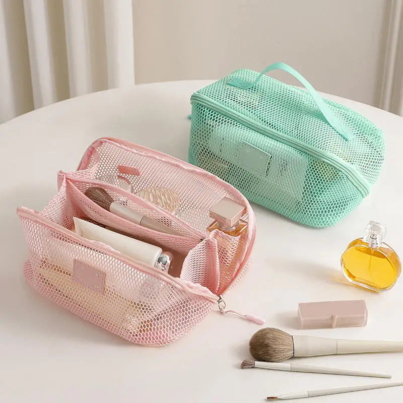 A pink mesh cosmetic organizer pouch and a mint green zippered pouch are displayed on a white surface.