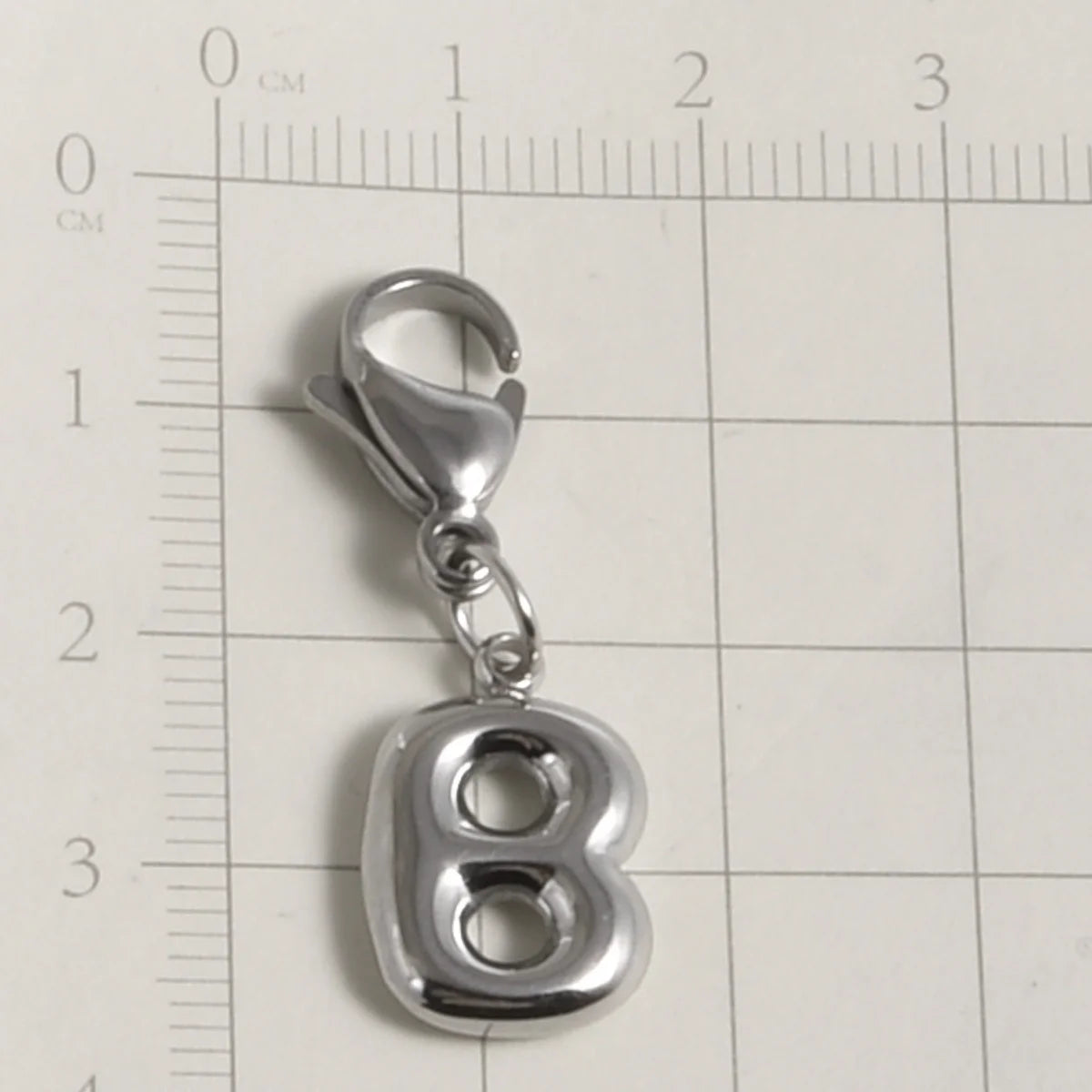 Silver stainless steel alphabet letter charm shaped like the number 8 with a lobster clasp