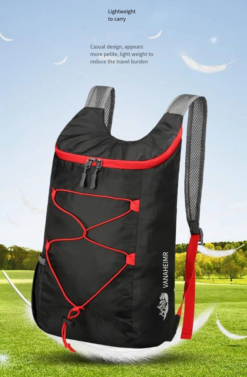 A black outdoor folding backpack with red accents is shown against a green field.