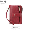 A red leather wallet with a zipper closure and a strap, described as wine red.