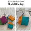 A model presentation display showing various colored waterproof travel toiletry bags on a white surface.