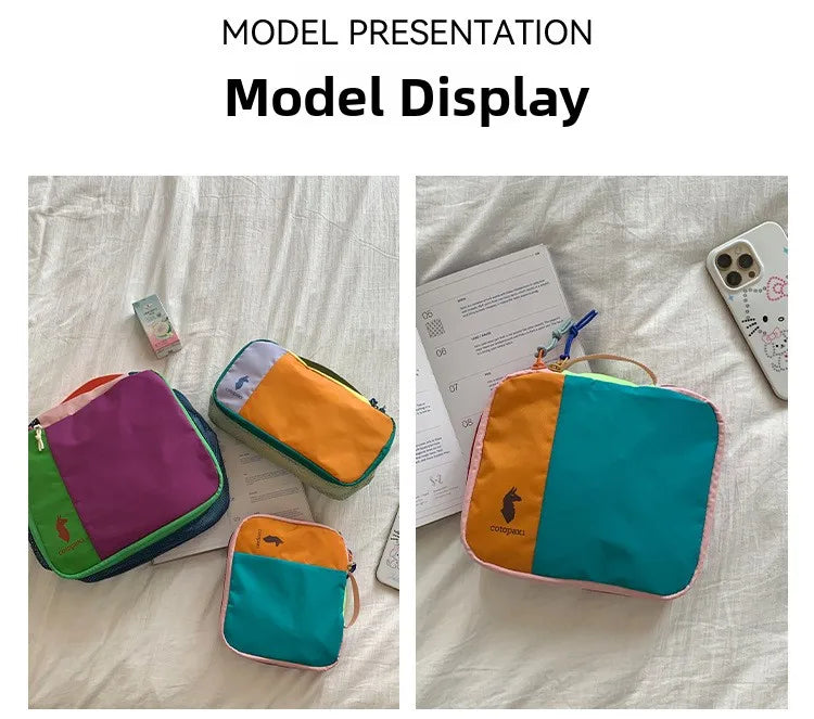 A model presentation display showing various colored waterproof travel toiletry bags on a white surface.