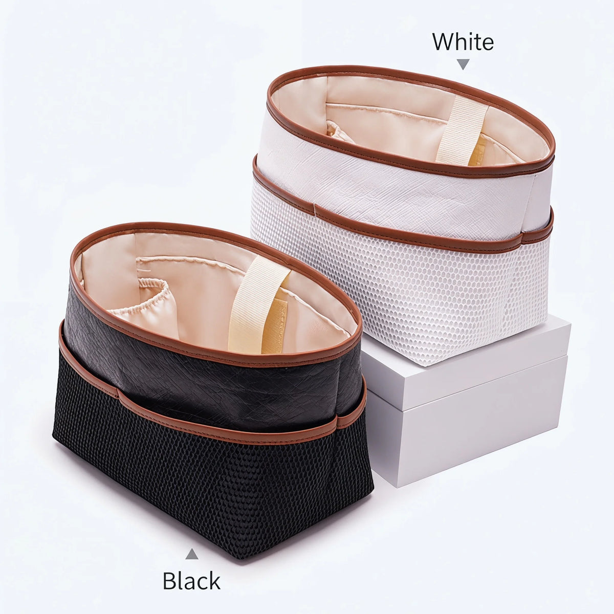 White and black tote bag organizer inserts showing laptop sleeves in a box.