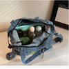 A blue denim crossbody bag is open, showing its interior lined with green and clear glass containers.