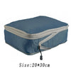 A blue reusable compression packing cube with a gray zipper and a black pull tab.