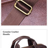 Detail display of a genuine leather briefcase showing the shoulder strap and leather handle.