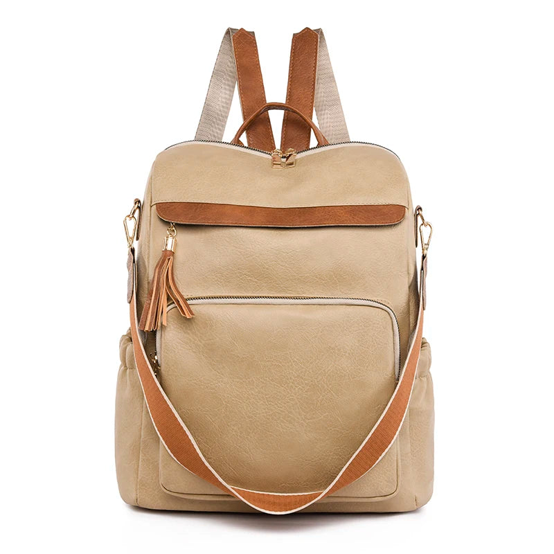 A tan leather backpack with brown accents and tassels shown from the back.