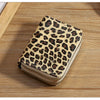 A beige leopard print double zipper wallet resting on a wooden surface.