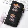 Black zippered wallet featuring a small, fluffy Highland cow print charm on a white background.