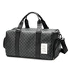 A black duffle bag with leather trim and handles is shown from the side.
