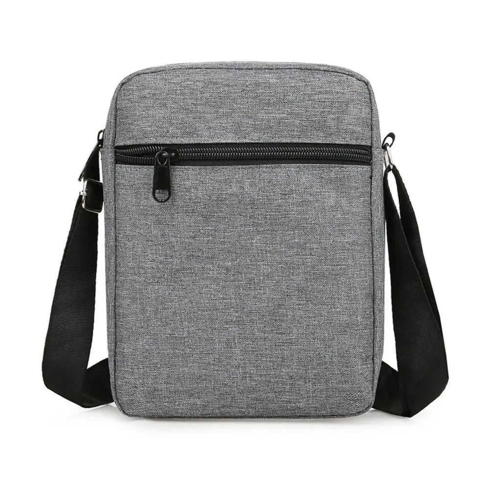 A gray durable waterproof crossbody bag with a black zipper and adjustable straps.