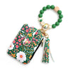 A green silicone bead necklace with a wooden charm and a PU leather key chain wallet featuring floral embroidery.