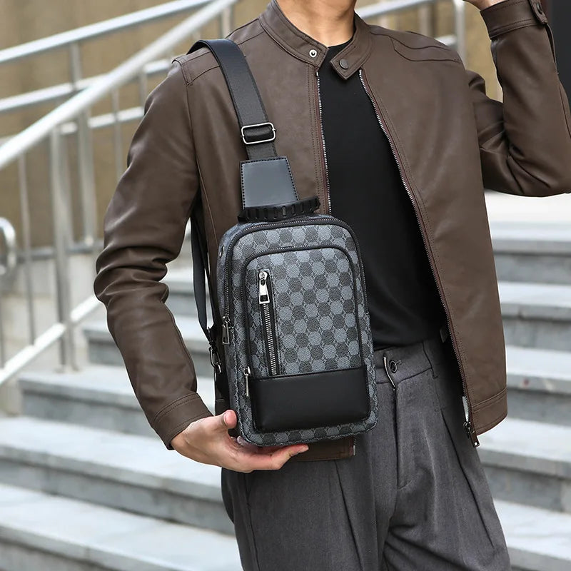 A man wearing a brown leather jacket and gray pants is holding a black geometric pattern crossbody bag.