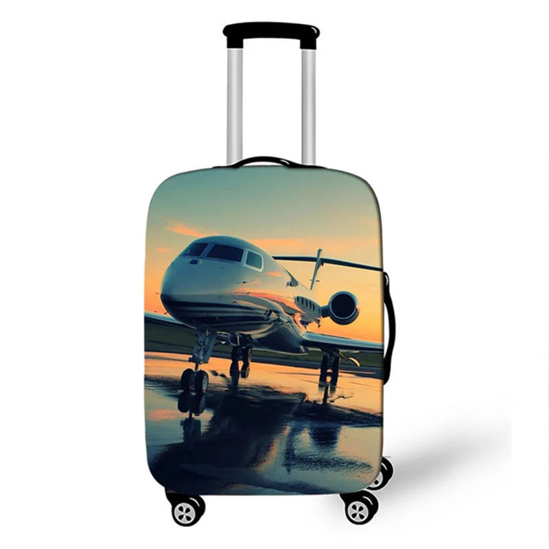A suitcase with a protective cover featuring an airplane silhouette against a sunset background.
