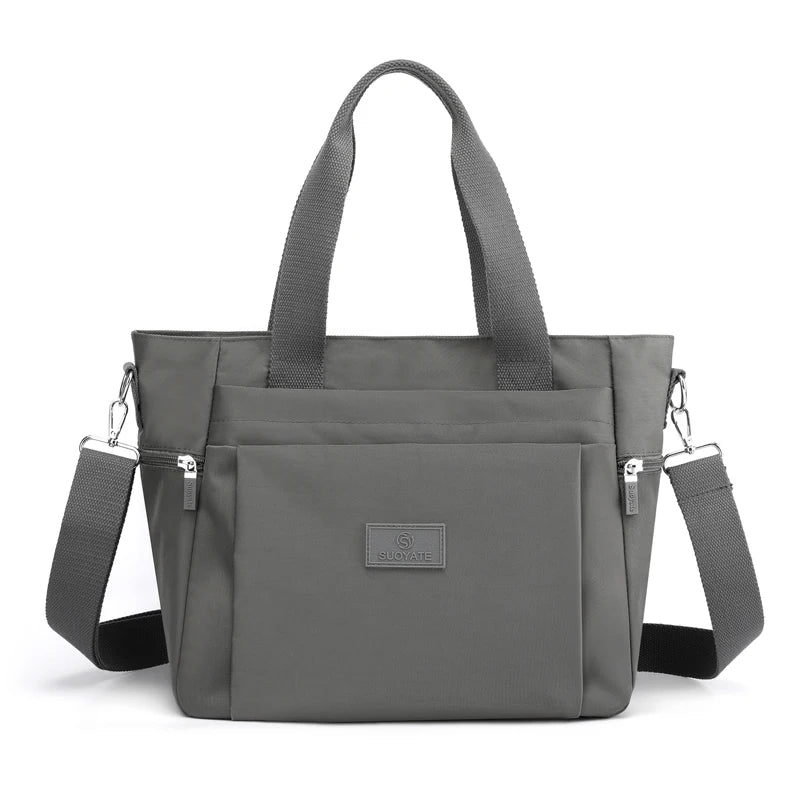 A gray durable nylon tote bag with padded straps and a secure zipper closure.