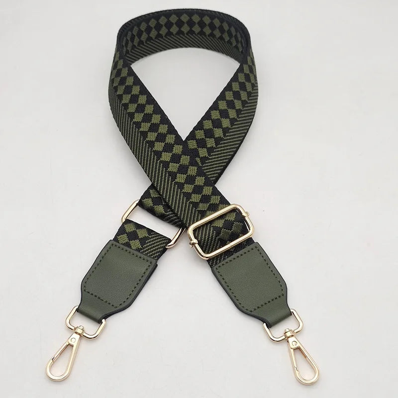 A close-up view of a dark olive green braided nylon strap with a checkered pattern and gold-toned metal hooks.