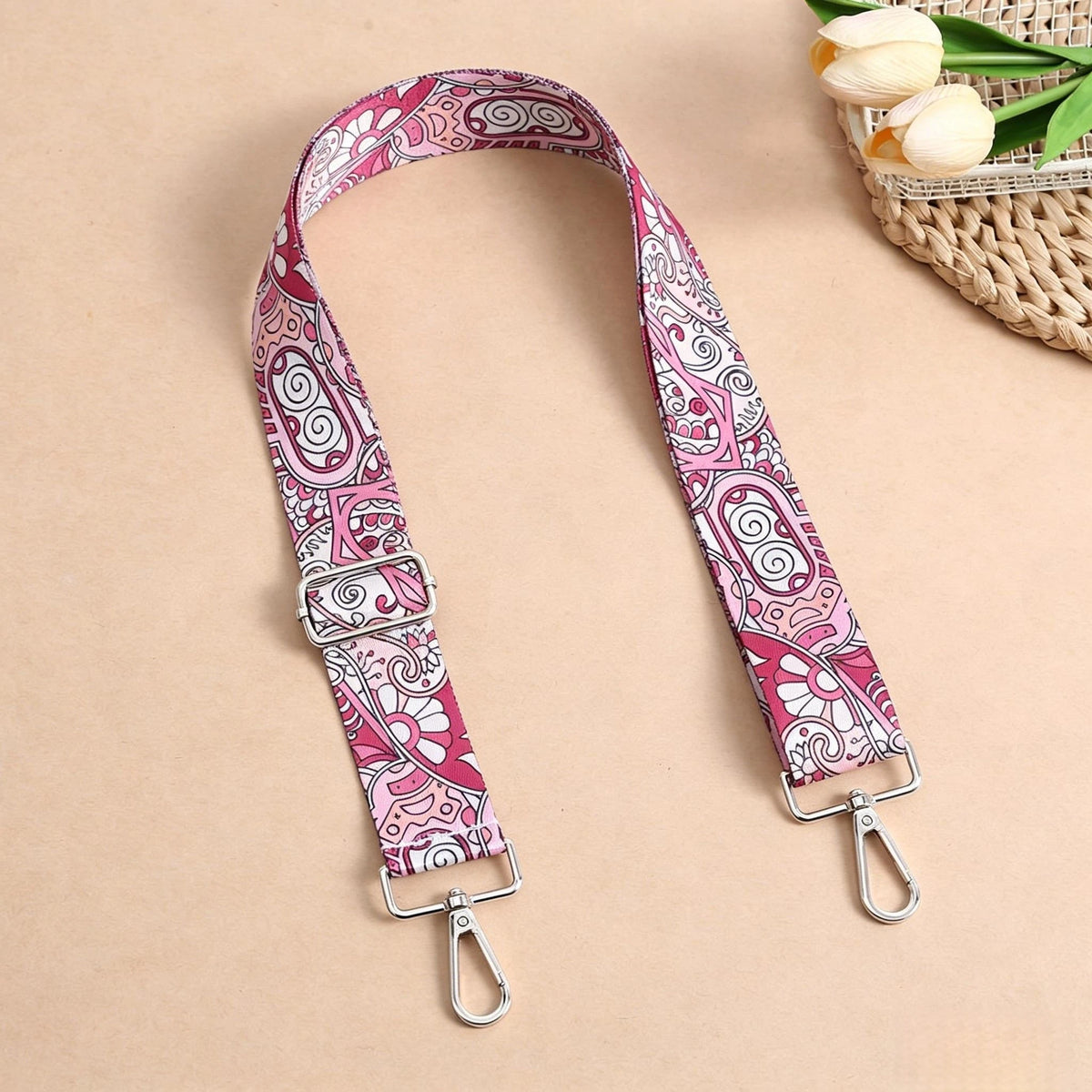 Pink and white paisley patterned nylon crossbody bag strap with metal buckles