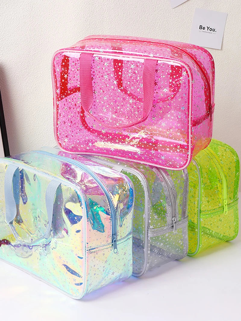 A pink and clear waterproof makeup organizer bag with glitter accents is displayed on a white surface.