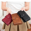 A collection of women's clutch wallets in various colors including pink, brown, grey, black, and wine red.