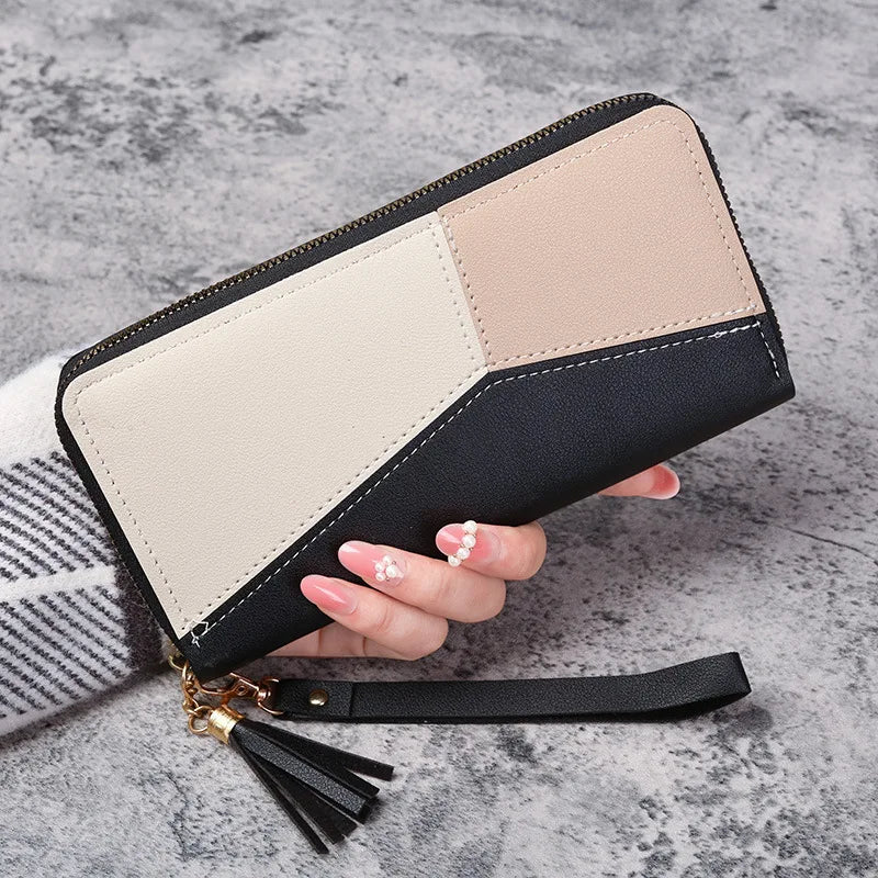 A beige and black checkered fashion zipper wallet for women is shown being held by a hand.