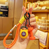 A hand holds an orange nylon fitness keychain with a yellow grip and an orange keyring.
