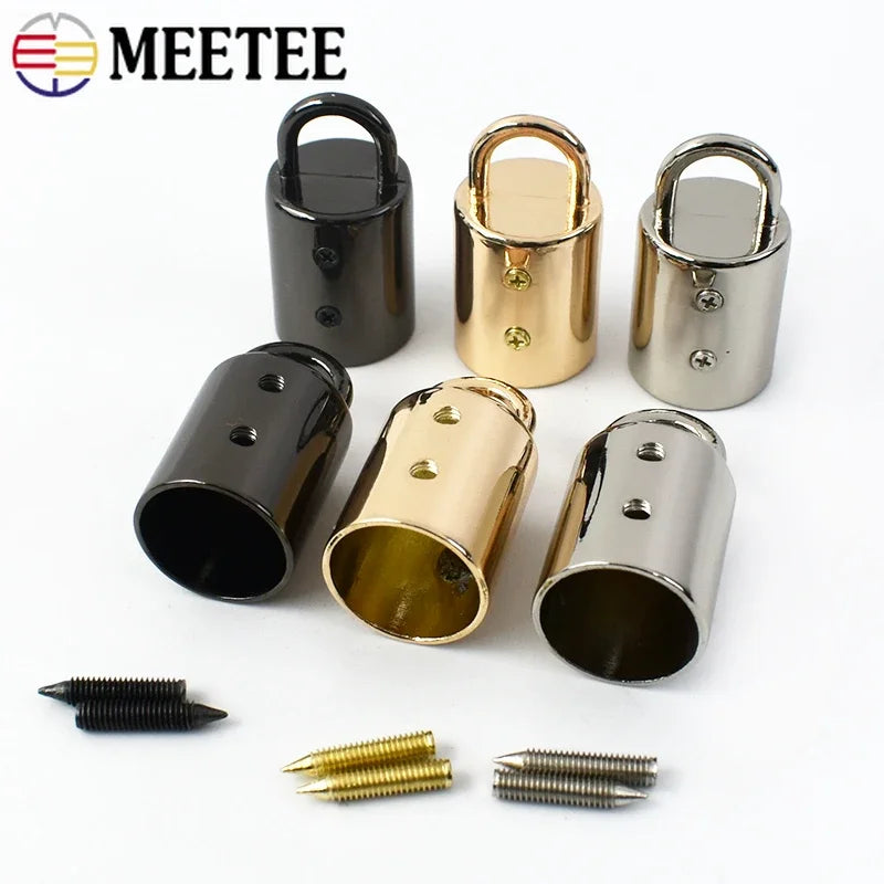 A collection of metal cord lock buckles in various sizes and finishes, including brass and silver tones.