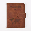A brown genuine PU leather passport and ticket wallet cover with embossed text and a world map design.