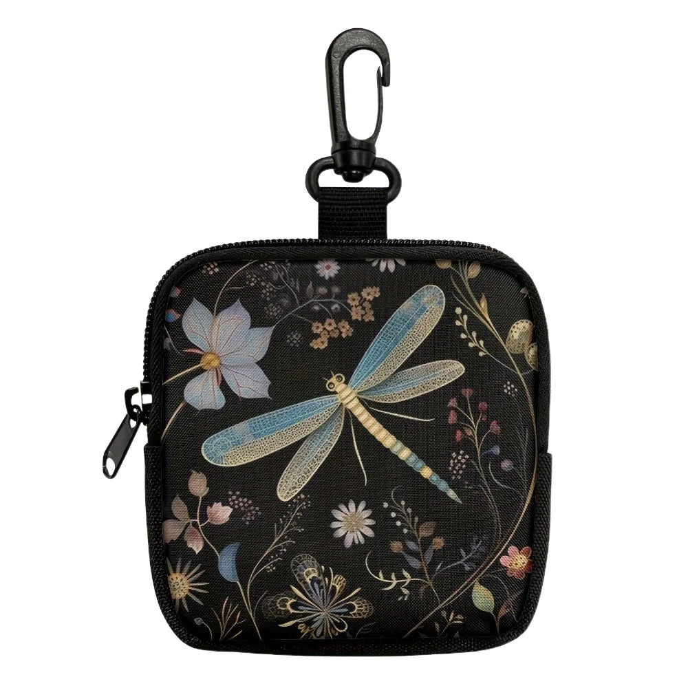 A black fabric coin purse with a flap closure featuring a floral and insect print.