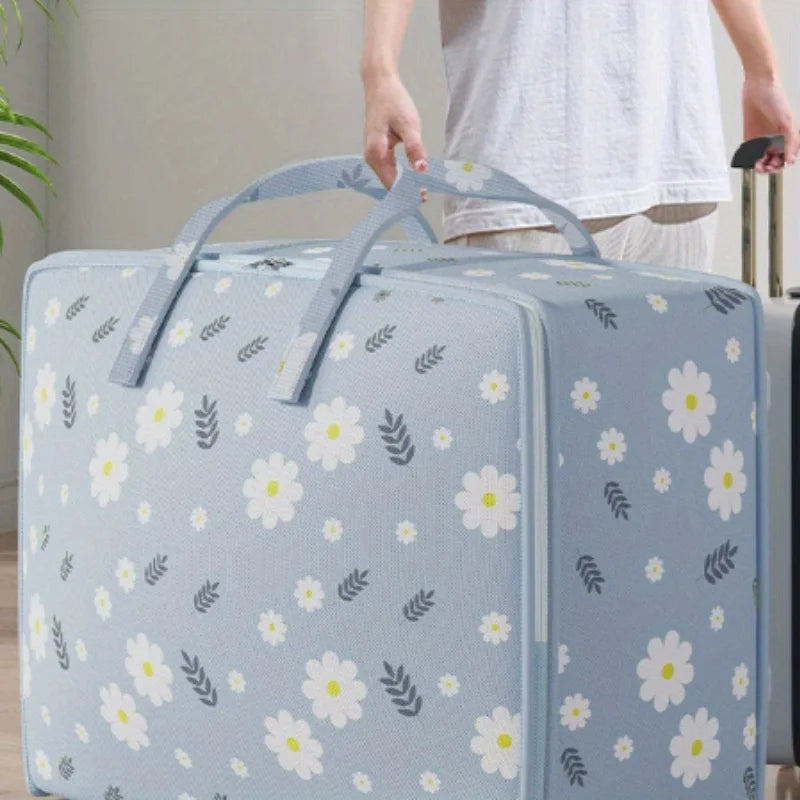 Light blue blanket storage bags with a floral pattern being held by a person.