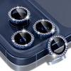 A close-up view of a blue camera lens protector with a glitter diamond lens and metal frame resting on a dark surface.