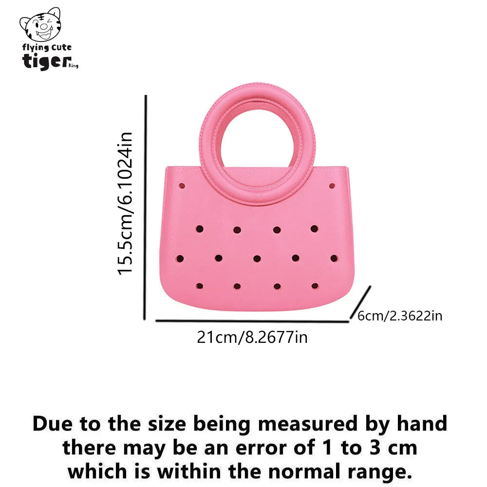 Pink round PVC handbag with a perforated design and a loop handle