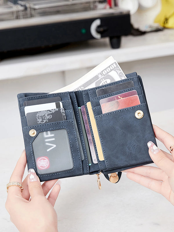 A hand holds a dark blue PU leather wallet with multiple cards and cash, featuring a visible embossed design.
