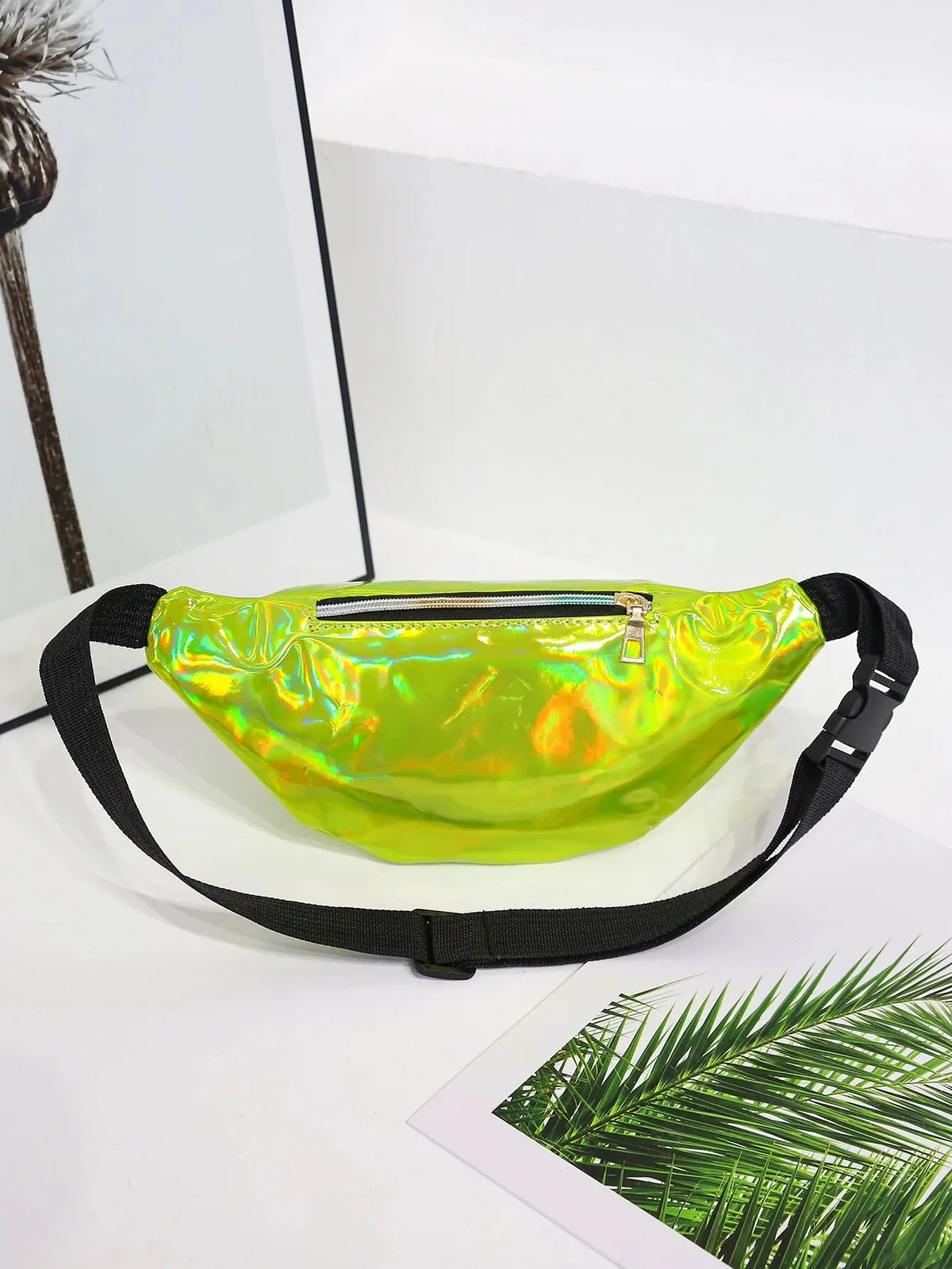 A bright lime green holographic sequin waist bag with a black adjustable strap displayed on a white surface.