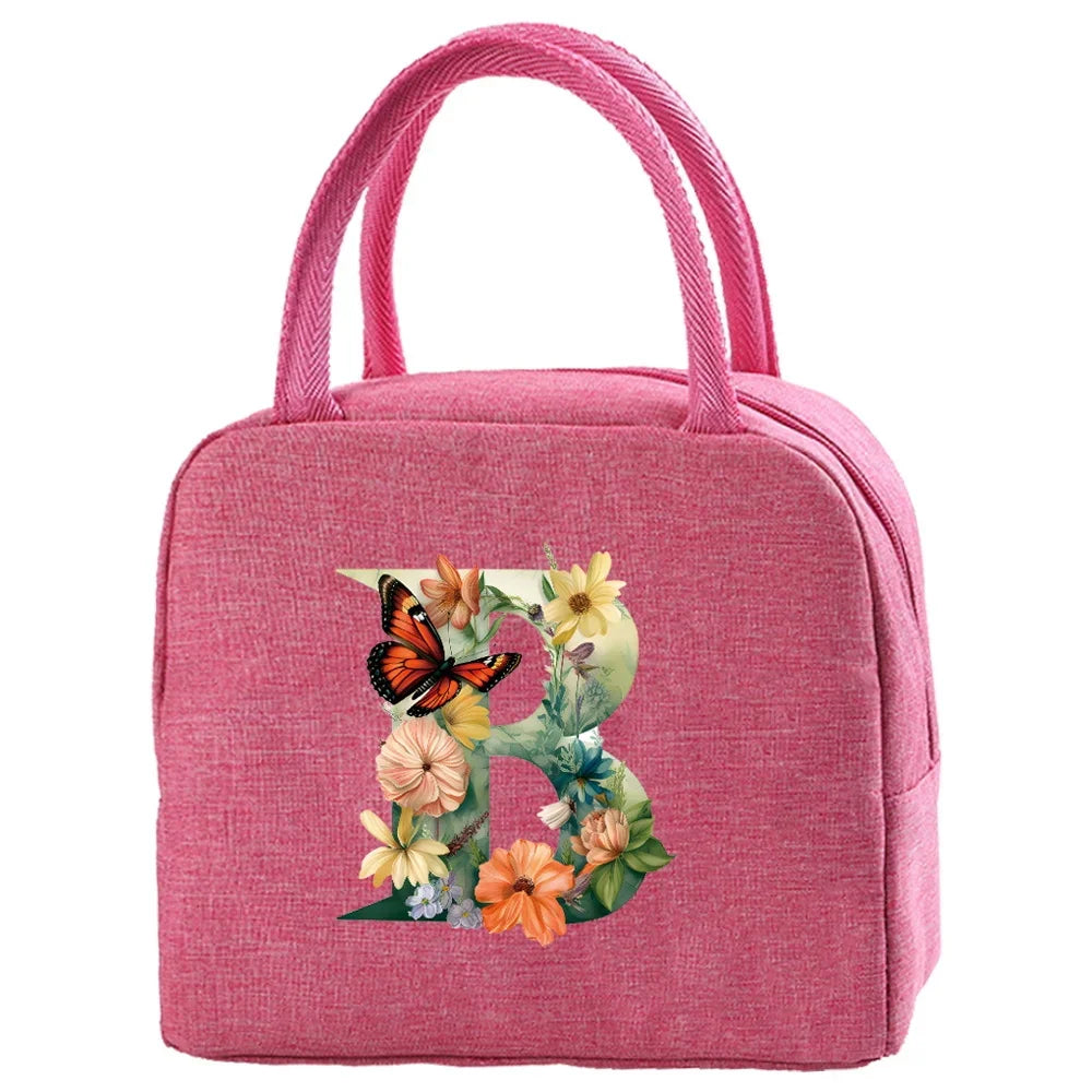 A pink insulated canvas lunch bag featuring a floral butterfly design.