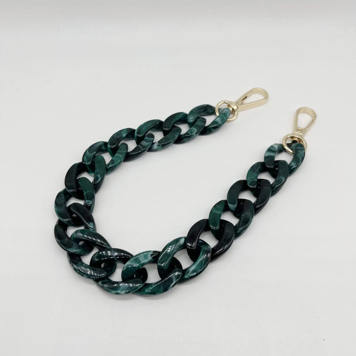 A dark green acrylic chain bracelet with gold-colored clasps.