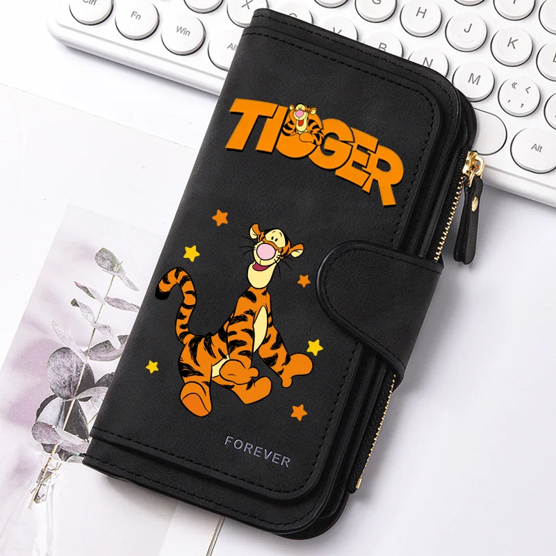 Black zippered clutch bag featuring an orange tiger graphic and gold accents, resting on a white surface.