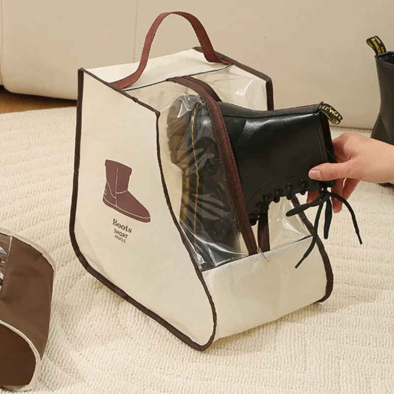 A beige canvas storage bag with a leather boot insert and a brown strap is shown on a white surface.