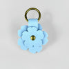 A light blue floral PU leather keychain with a gold-toned ring and a matching fabric charm.
