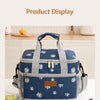 A blue and white insulated thermal lunch bag is displayed on a white table with lemons and food items nearby.