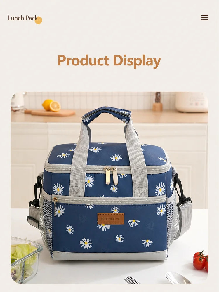 A blue and white insulated thermal lunch bag is displayed on a white table with lemons and food items nearby.