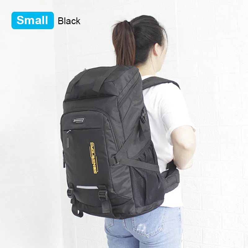 A black large capacity travel backpack with a rain cover is shown on a person's back.