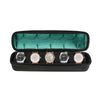 Black watch organizer case with a green soft lining holding four watches.