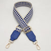 A braided nylon bag strap featuring a blue and beige checkered pattern with gold-toned metal hooks.
