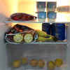 A display of reusable waterproof snack bags filled with fresh fruit like apples, tomatoes, and bananas.