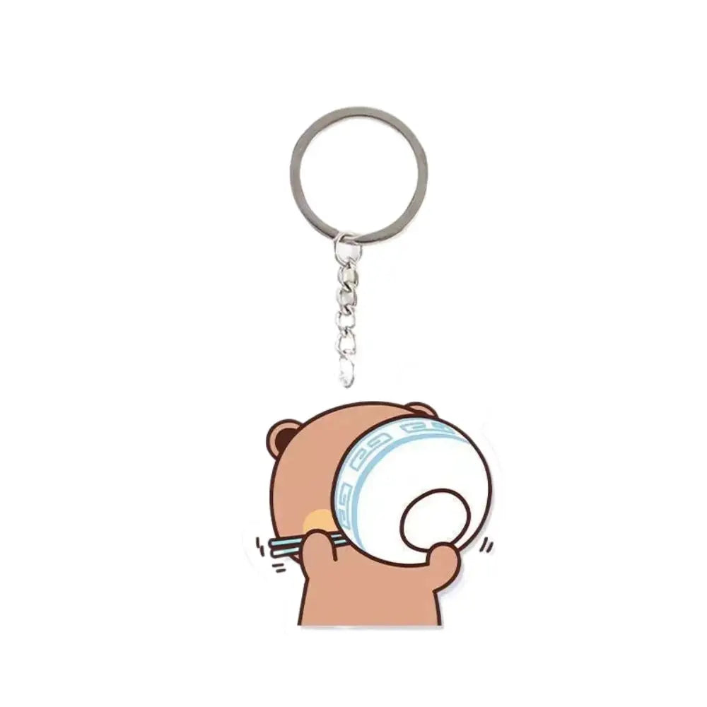 A cartoon character hand holding a white bowl, attached to a silver keychain charm.