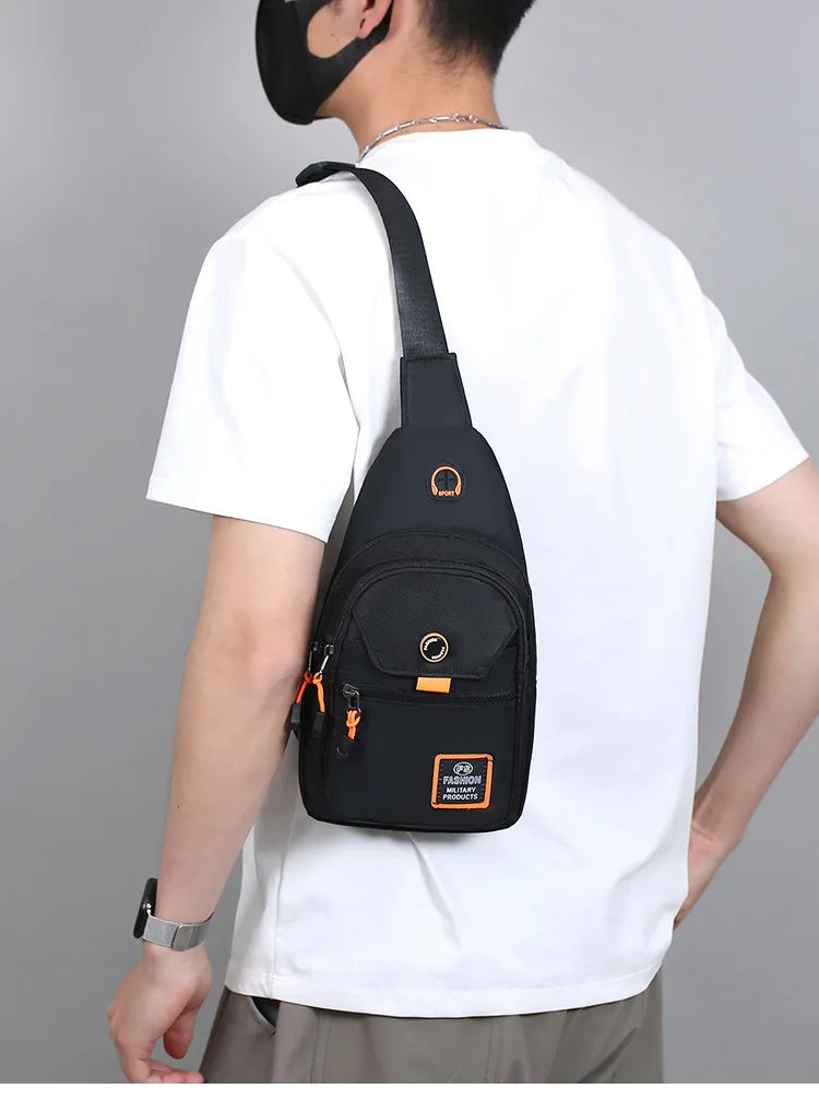 A person wearing a white t-shirt and black mask is holding a black compact oxford crossbody sling bag.