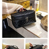 Black large capacity PU embroidery makeup storage pouch displayed on a marble surface.