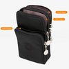 Black nylon crossbody phone bag featuring two main compartments and a front pocket with decorative chains
