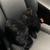 A black, fuzzy bowknot car headrest pillow and lumbar support placed in a gray car seat.
