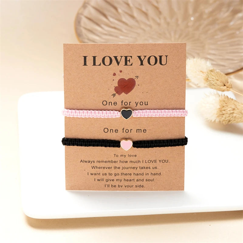 Two beaded friendship bracelets with 'I love you' messages and heart charms presented in kraft paper.